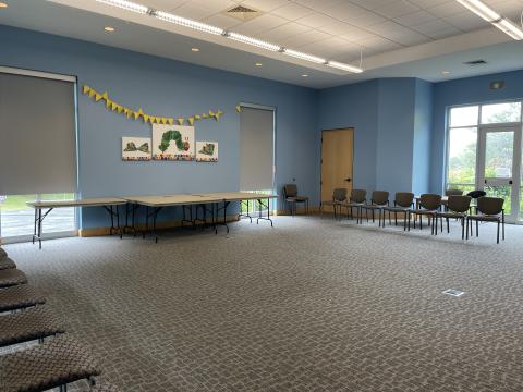 carpeted room with tables against one wall and chairs