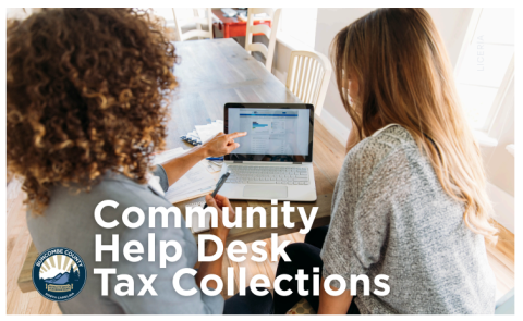 Two women sit at a laptop with their backs facing the camera. The Buncombe County Government logo sits bottom left on the screen, with the words, "Community Help Desk Tax Collections" in white. 